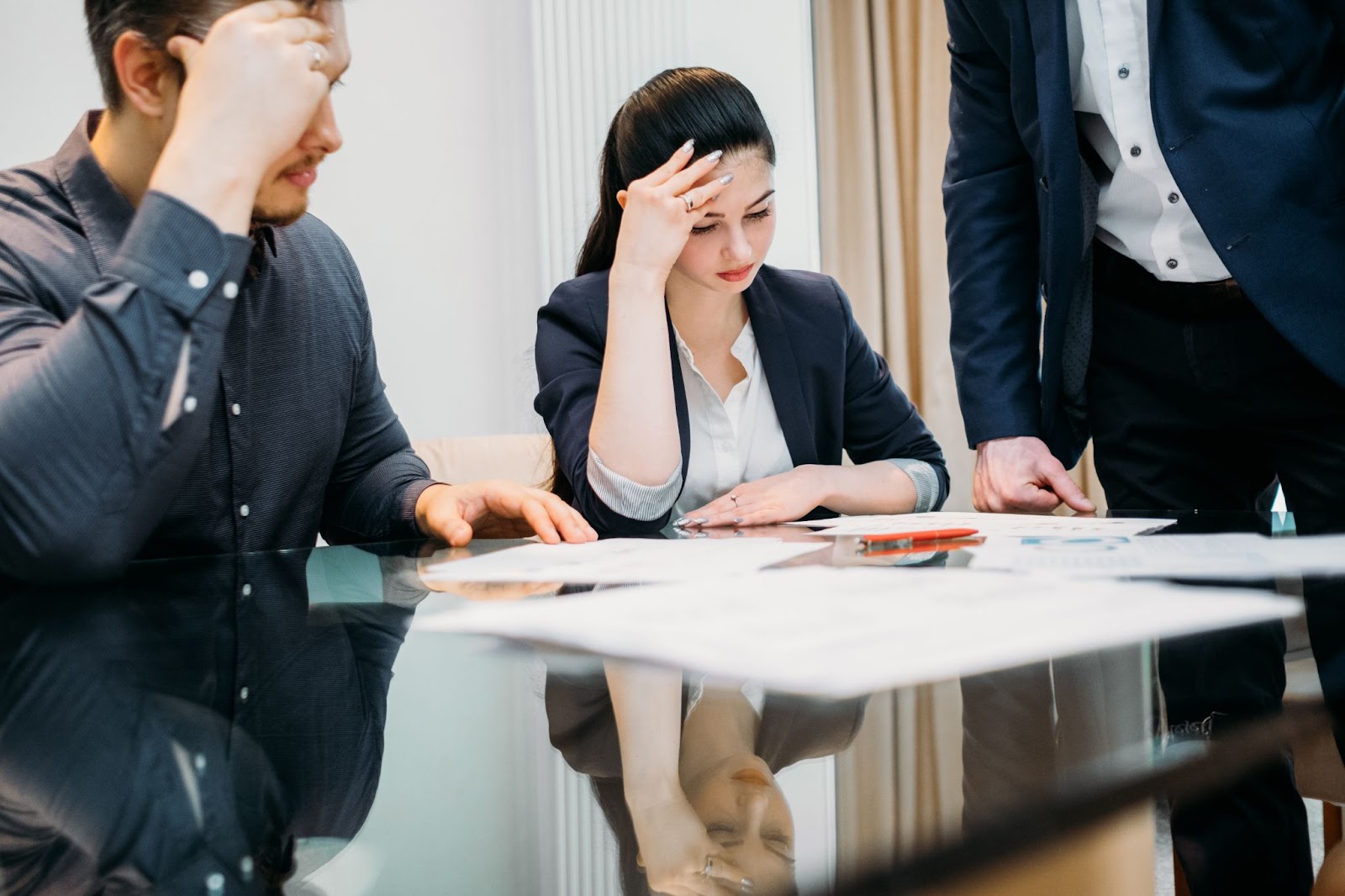 A man and woman at a table with papers, discussing divorce consultation with a divorce attorney.