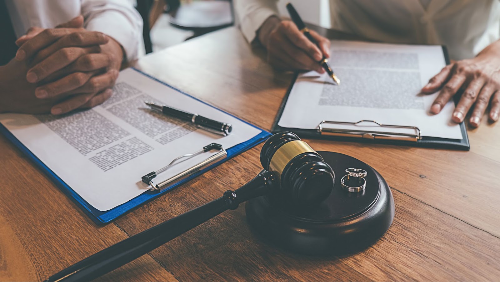 Lawyers and judge signing divorce documents during a consultation.