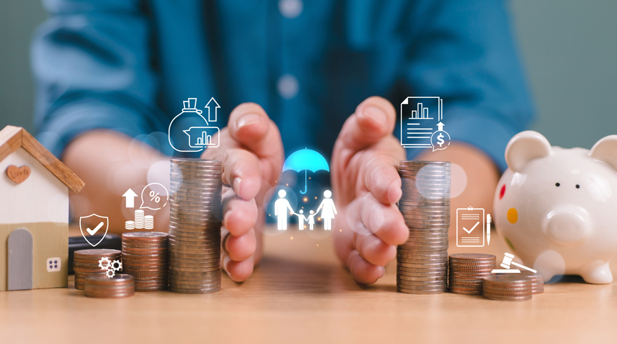 A professional man displays multiple stacks of coins and cash, representing wealth accumulation and financial growth.