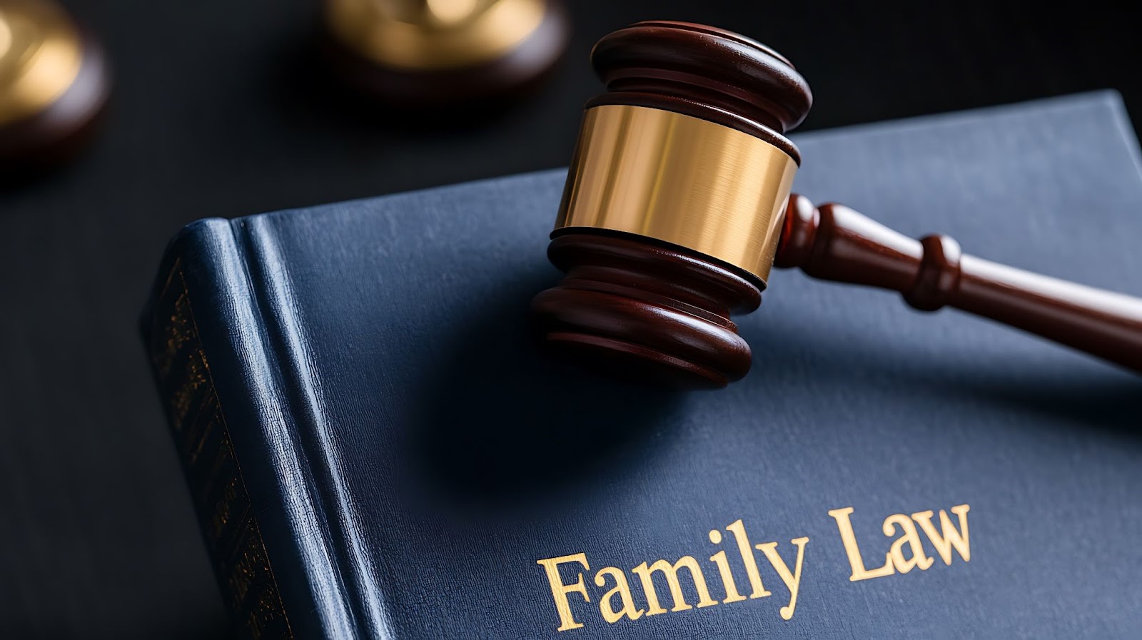 A wooden gavel resting on a Family Law book, with additional gavels in the background.