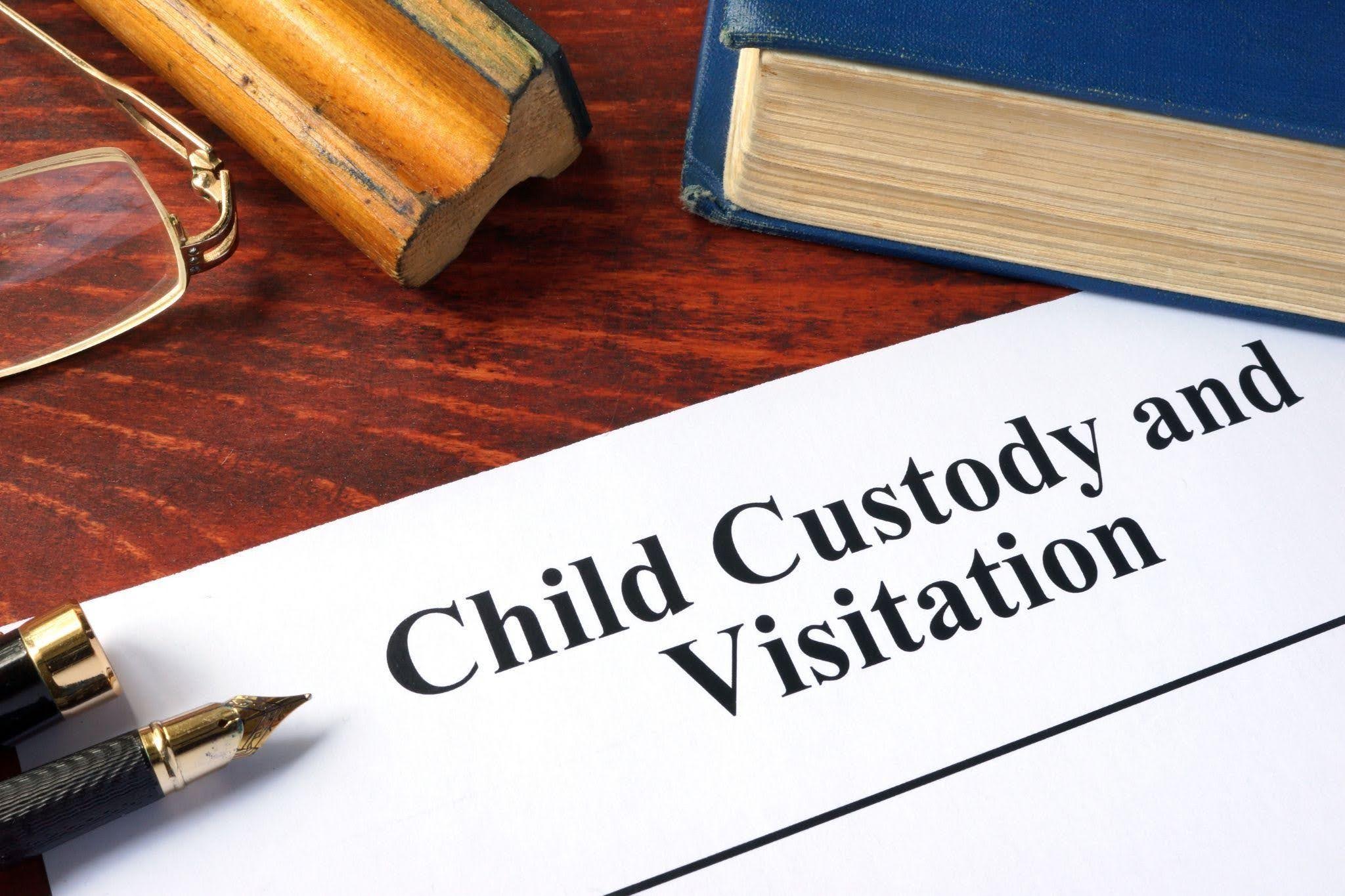 A gavel and family photo symbolizing child custody and visitation arrangements in a legal context
