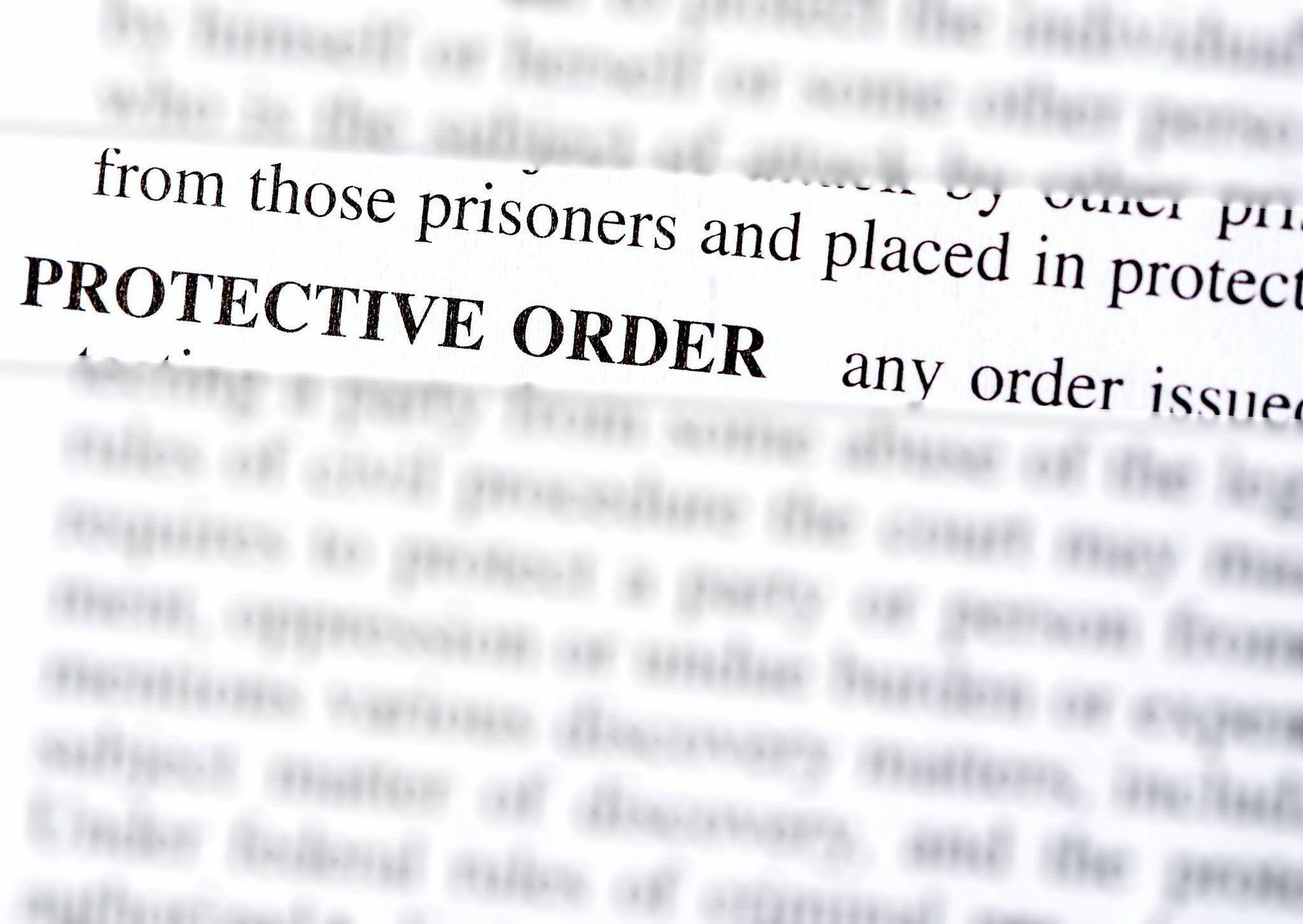 Text highlighting Protective Order in bold letters surrounded by blurry document text